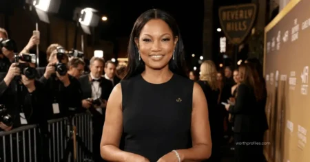 Garcelle Beauvais Net Worth Garcelle Beauvais attending a red carpet event in a glamorous black dress